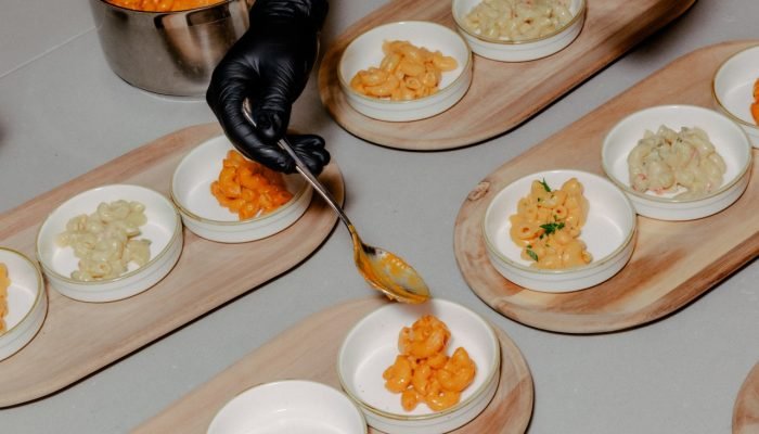 Chefs da Conagra preparam tigelas de macarrão com queijo para degustação.